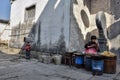 HUNGCUN VILLAGE, ANHUI PROVINCE, CHINA Ã¢â¬â CIRCA OCTOBER 2017: A woman siting behind the metal barrels